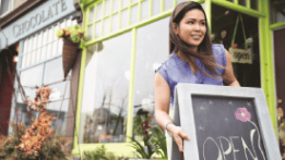 Entrepreneur opening shop after signing up for new business banking accounts